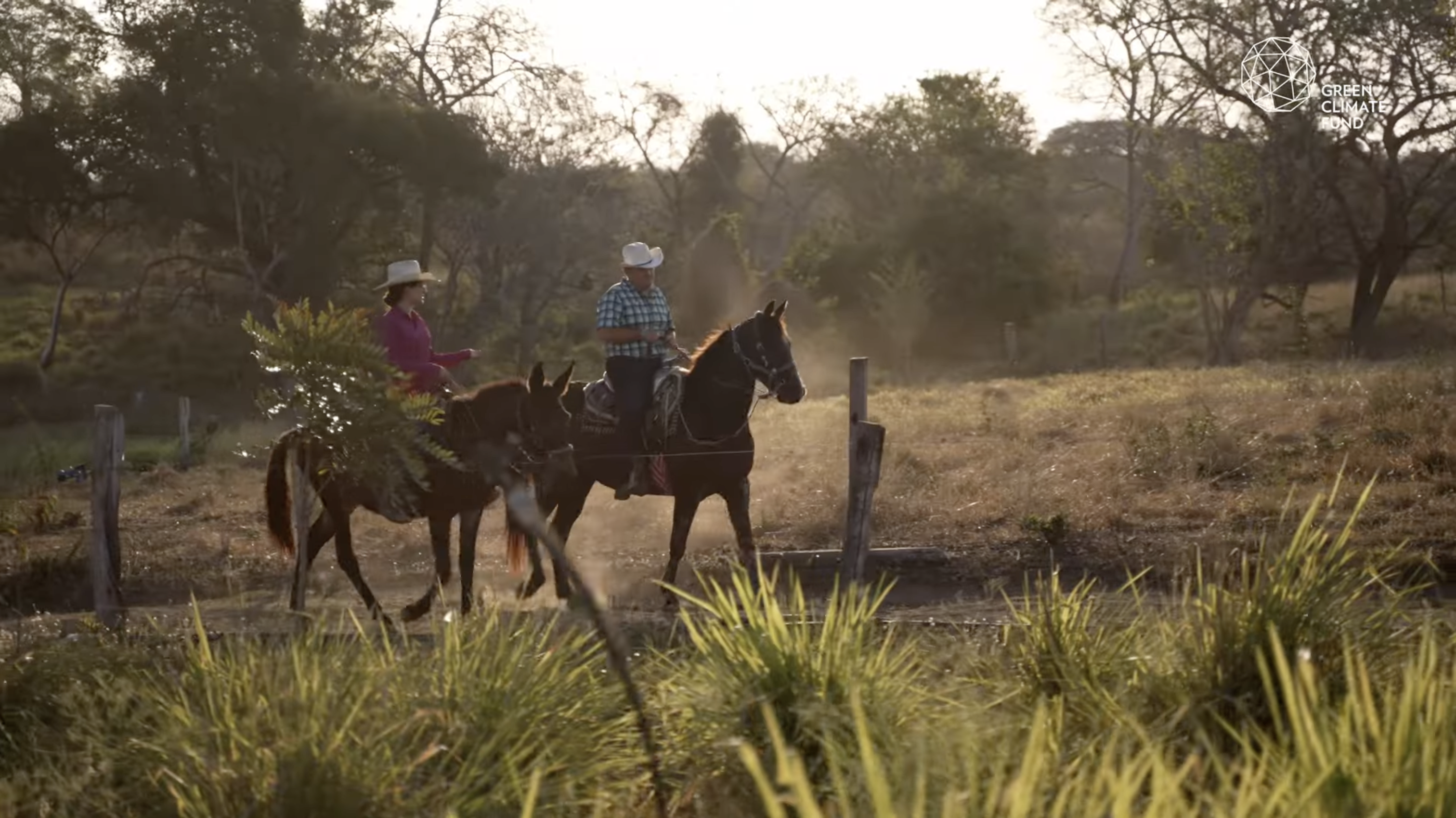 Two mexican ranch workers riding horse