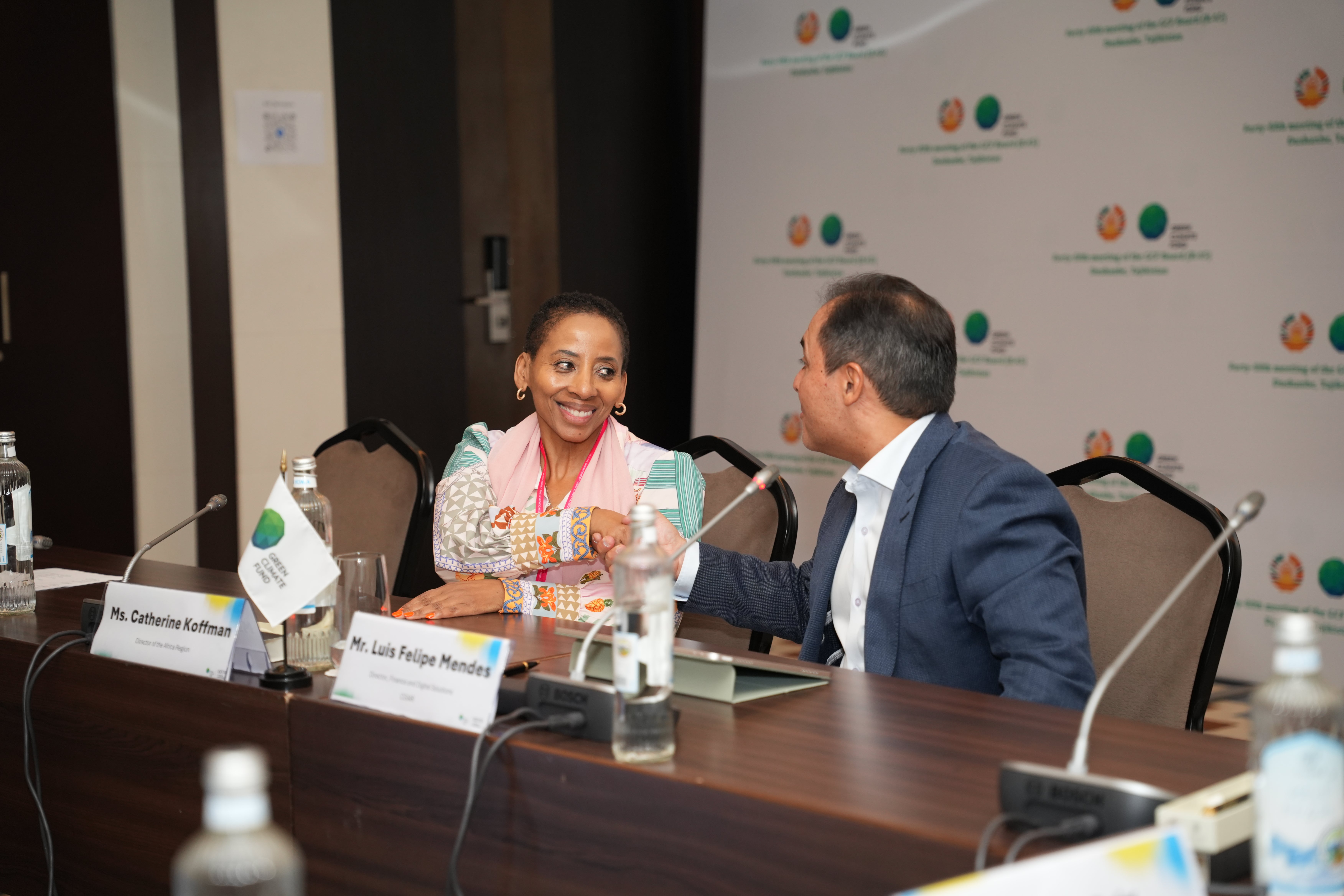 Director of the Department of the Africa region congratulating counterpart in a signing ceremony