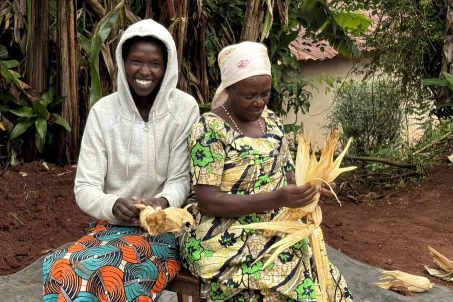 Two African women peeling corn
