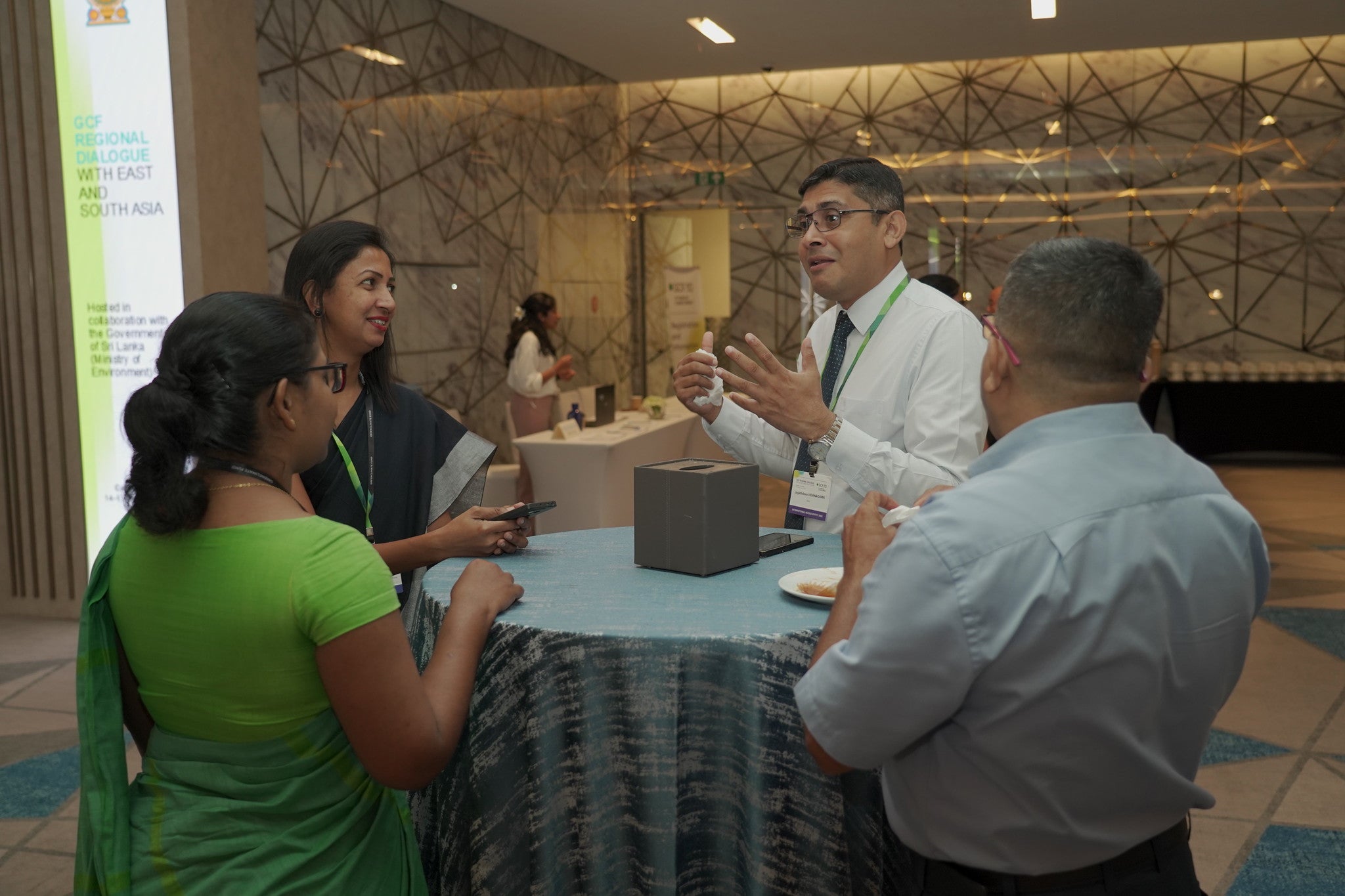 Participants chatting over a small roundtable at the Regional dialogue with East and South Asia