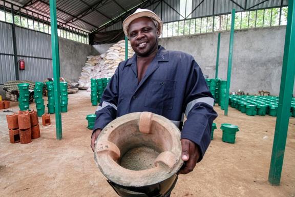 Bruce Kimathi showcasing a stove produced in his new ICS workshop facility next to his old workshop in Tharaka-Nithi County, Kenya.