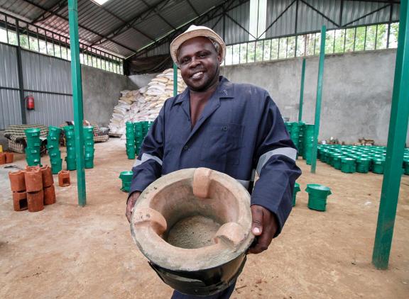 Bruce Kimathi showcasing a stove produced in his new ICS workshop facility next to his old workshop in Tharaka-Nithi County, Kenya.