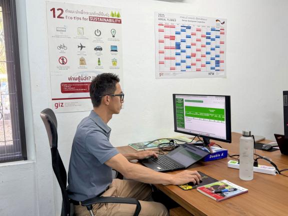 Khamla Nanthavong, National Forestry Adviser, searches the database for information on the progress of programme implementation. Photo: GIZ/I-GFLL .