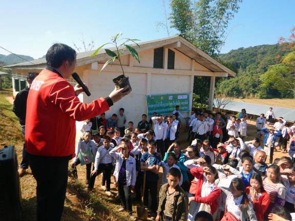 A forestry expert engages students in Huaphan Province, demonstrating the importance of tree planting for environmental restoration. 115 students participated in planting 150 fruit trees, contributing to forest recovery and sustainable land management. Photo: Vilatsay Lattanavong/GIZ