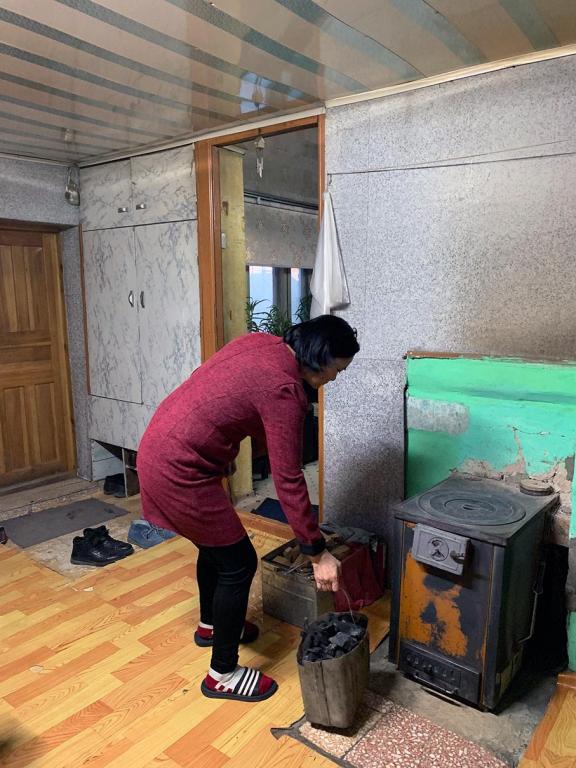 Women in the family are traditionally responsible for keeping the house warm during winter. Here, Otgonbayar, gets ready to put coal briquettes in the furnace. Photo: GCF/Angeli Mendoza