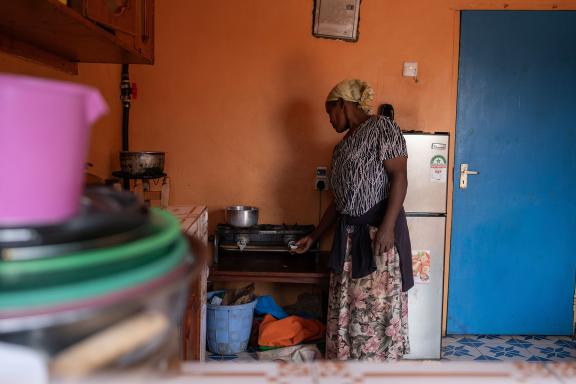 Beth Nyokabi Njatha boils water at her home in Kirinyaga County, Kenya. Since the installation of a biodigester from Sistema.bio, a local biodigester company supported by KawiSafi, she's seen her gas bills drop and her crop yields rise. Through GCF financing, communities have greater access to innovative technology that help them respond to the effects of climate change. Photo © Andy, Ball/Green Climate Fund